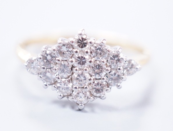 A modern 18ct gold and diamond set marquise shaped cluster ring, size M, gross weight 2.9 grams